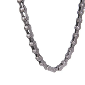 Close-up of a silver metal bicycle chain hanging in a U-shape on a plain white background.