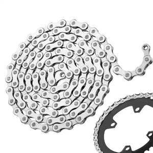 A silver metal 7-speed bicycle chain coiled in a spiral with a chainring partially visible at the bottom right, on a plain white background.