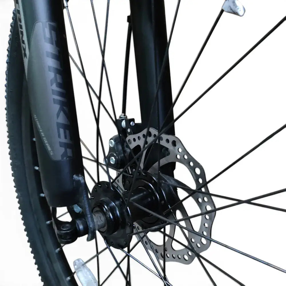 Front mechanical disc brake rotor and suspension fork on Trinx K024 24-inch mountain bike
