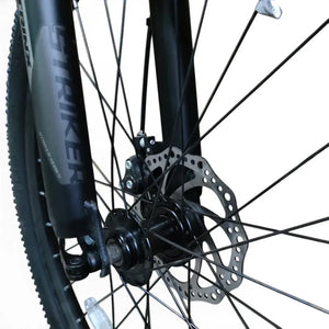 Front mechanical disc brake rotor and suspension fork on Trinx K024 24-inch mountain bike