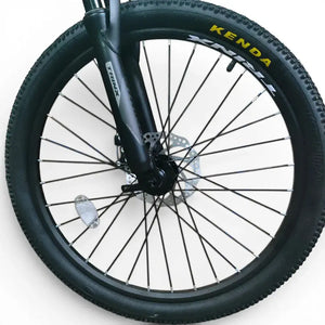 Front wheel of Trinx K024 mountain bike featuring black alloy rim, Kenda tire, mechanical disc brake rotor, and spoke reflector