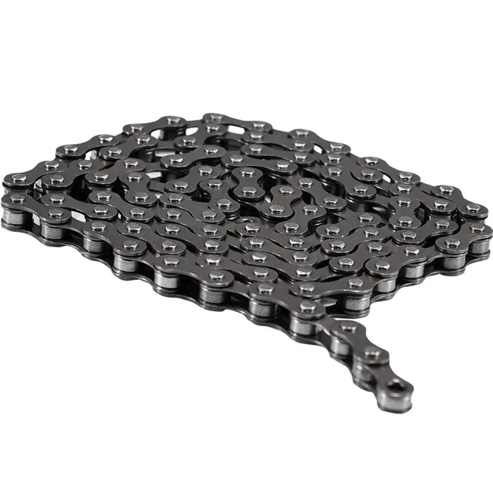 Dark metallic bicycle chain folded neatly in flat parallel rows on a plain white background.