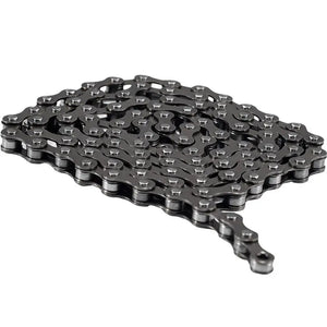 Dark metallic bicycle chain folded neatly in flat parallel rows on a plain white background.