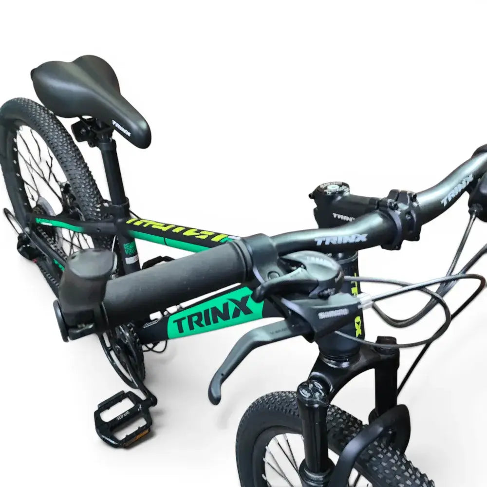 High-angle front view of green and black Trinx K024 24-inch mountain bike showing handlebars and frame