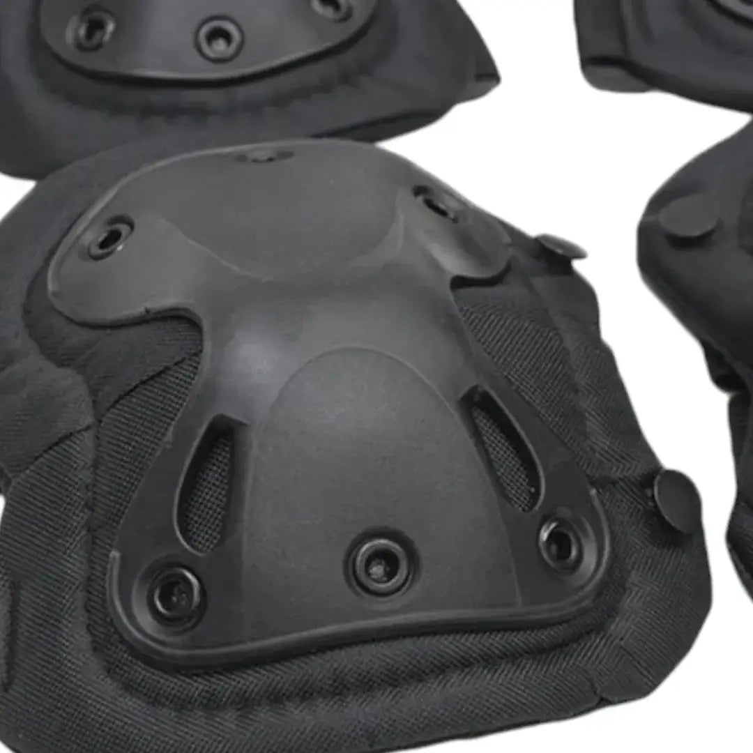 Close-up of a black protective pad showing the contoured outer shell, rivets and padded fabric edges.