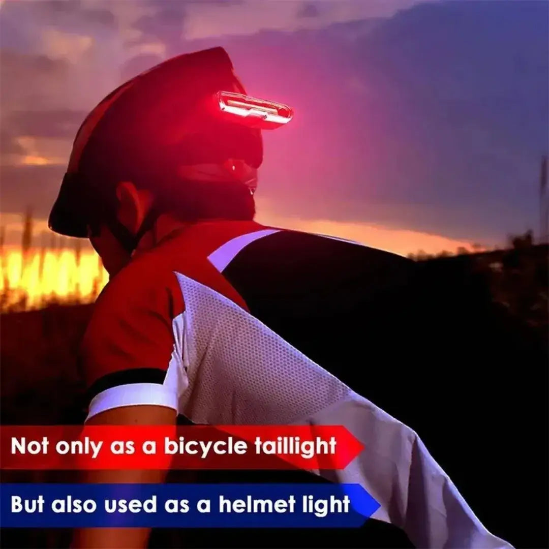 Red LED bicycle safety light mounted on the back of a cyclist's helmet at sunset.