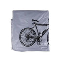 Folded silver bicycle protective cover featuring a black bike graphics print, isolated on white background