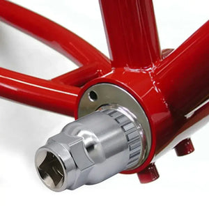 Bicycle bottom bracket removal socket tool attached to frame.