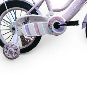 Close-up of purple Roadix girls bicycle chain guard, pedal, and training wheel