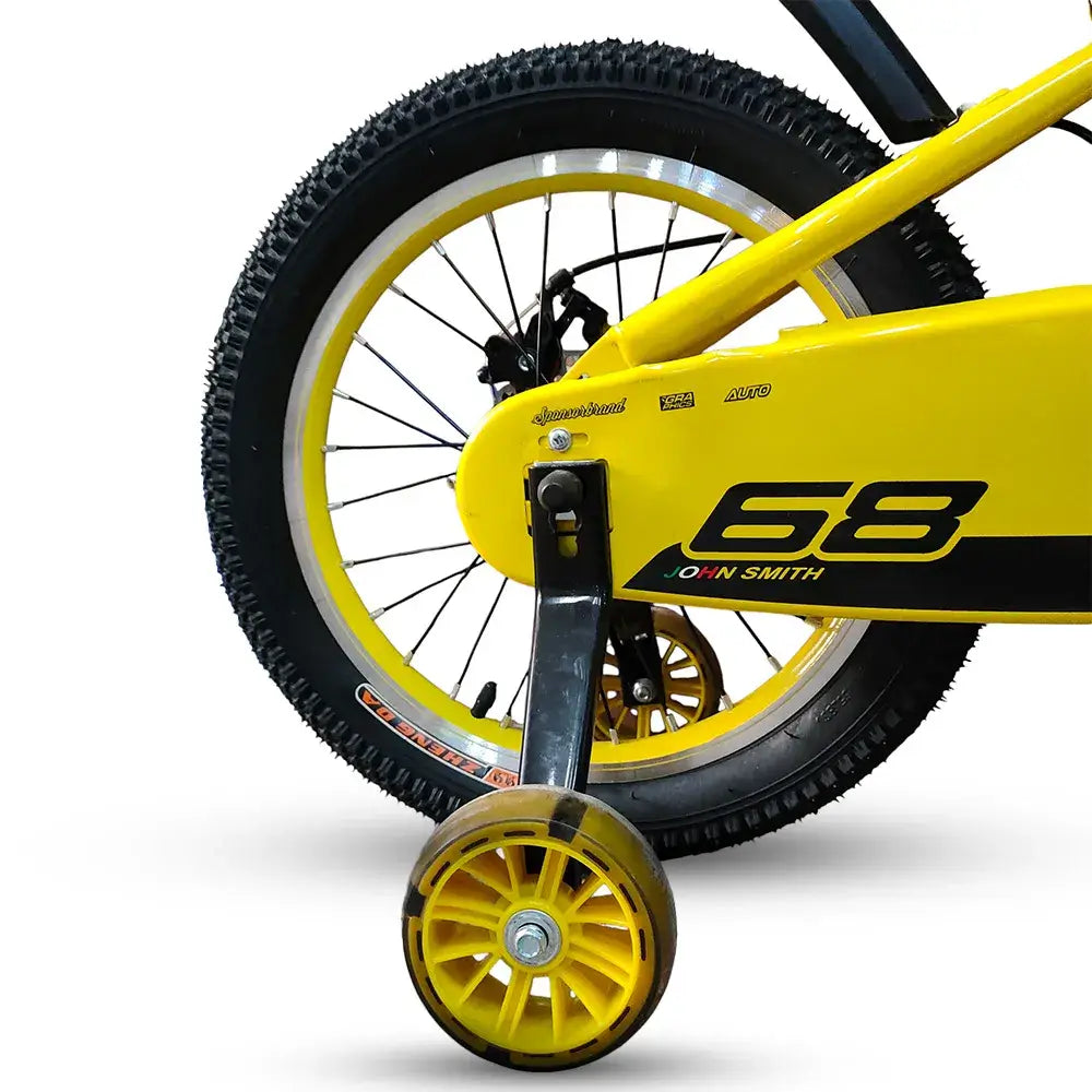Close-up of RF 16-inch yellow kids bike rear wheel, chain guard, and yellow training wheel