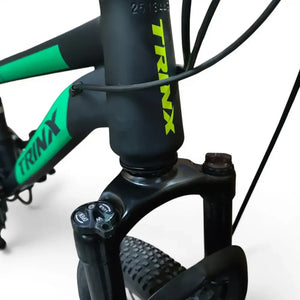 Close-up of Trinx K024 mountain bike front head tube with logo and suspension fork