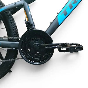 Detailed view of Trinx K024 mountain bike triple crankset, chainring with guard, platform pedal, and front derailleur on a matte frame