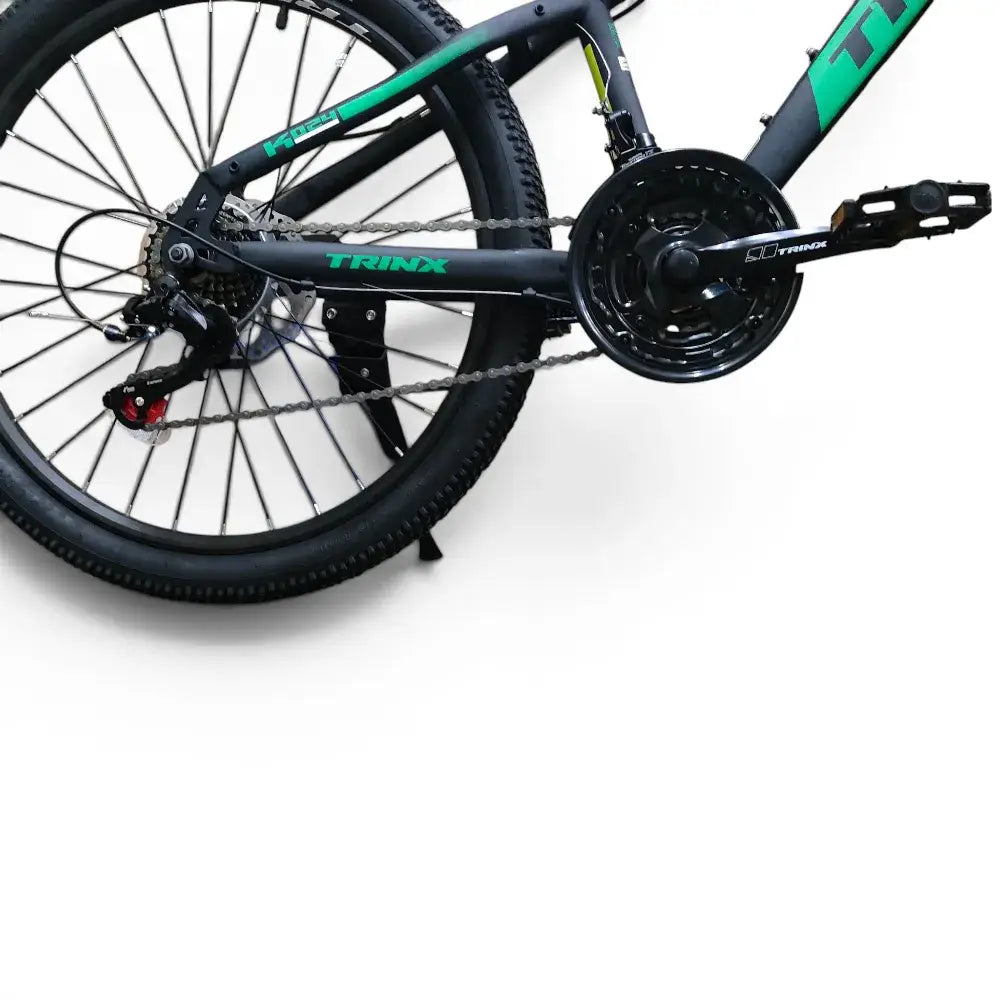 Trinx K024 24-inch mountain bike drivetrain showing chainring, pedal, and rear wheel assembly