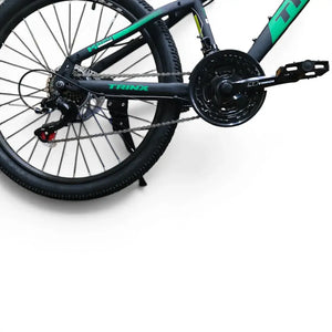Trinx K024 24-inch mountain bike drivetrain showing chainring, pedal, and rear wheel assembly