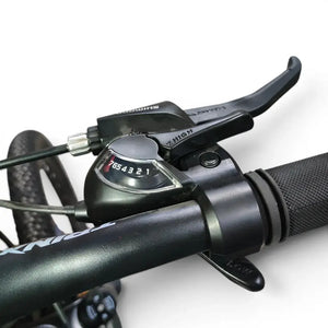 Close-up view of Trinx K024 mountain bike Shimano 7-speed shifter dial, integrated brake lever, and ergonomic handlebar grip