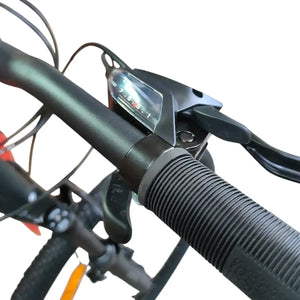 Close-up of Trinx 007 PRO mountain bike handlebar showing textured rubber grip, Shimano gear shifter, and brake lever.