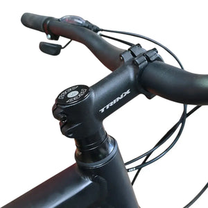Close-up view of Trinx 007 PRO bicycle handlebar stem and headtube with white Trinx logo.