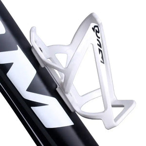 White bicycle water bottle cage mounted on a black bike frame