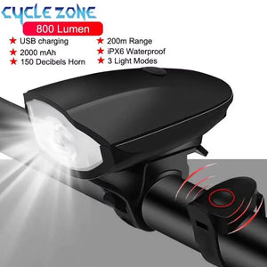 Black bicycle headlight and electronic horn installed on handlebar with illuminated LED beam and spec overlay.