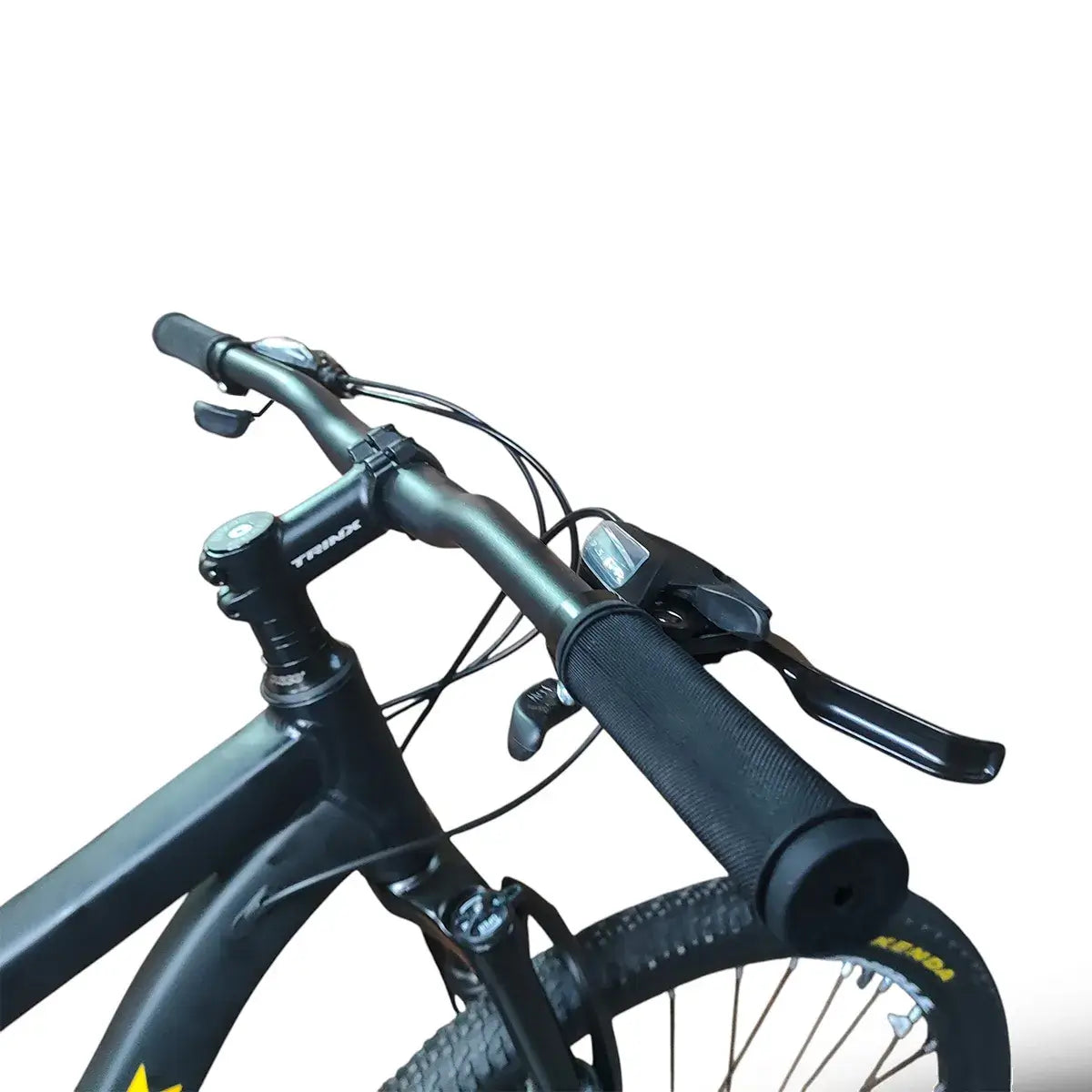 Close-up of Trinx M007 PRO mountain bike handlebars, showing black rubber grips, brake levers, shifters, and cable setup on a matte black frame.