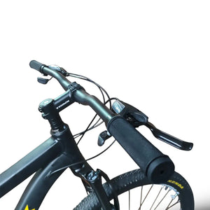 Close-up of Trinx M007 PRO mountain bike handlebars, showing black rubber grips, brake levers, shifters, and cable setup on a matte black frame.