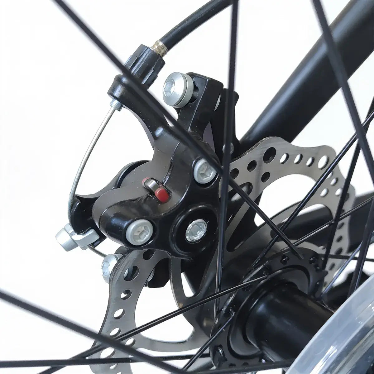 Close-up view of mechanical disc brake assembly and wheel hub on Trinx K026 mountain bike, isolated on white background
