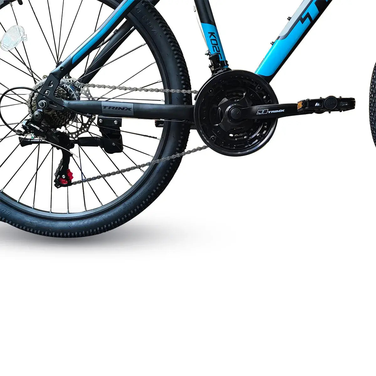 Close-up view of bicycle drivetrain showing rear wheel, cassette, chain, and rear derailleur on Trinx K026 mountain bike, isolated on white background