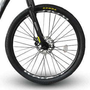 Close-up view of Trinx mountain bike front wheel featuring Kenda tire and disc brake, isolated on white background