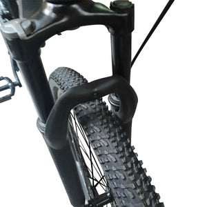 Close-up view of Trinx mountain bike front suspension fork and Kenda tire, isolated on white background