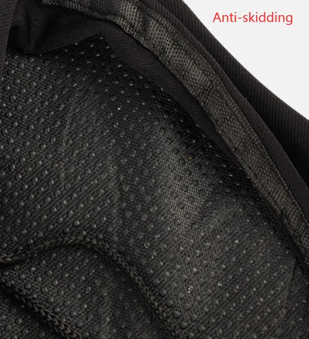 Close-up view of non-slip textured fabric backing on a black bicycle saddle cover with red text 'Anti-skidding'