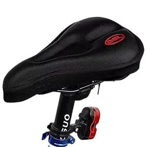 Black gel padded bicycle saddle cover with red logo installed on bike seat post against white background